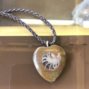 Hand painted heart shaped pendant paired with a braided faux leather cord
